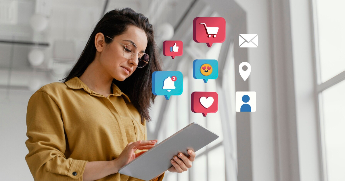 A woman holding a tablet displaying various social media icons, engaged in digital marketing trends 2025